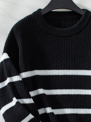 Black ribbed knit sweater with white horizontal stripes and crew neck.