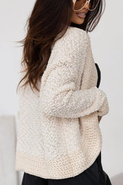 Cream bouclé open-front jacket with textured knit and relaxed fit.
