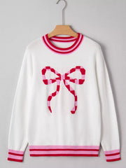 White round-neck sweater with a pink and red checkered bow graphic and striped cuffs and hem.