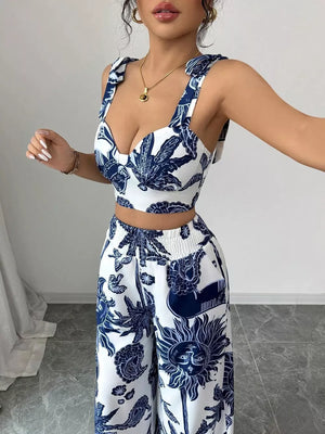 Blue and white tropical print crop top and wide-leg pants set with tie straps.