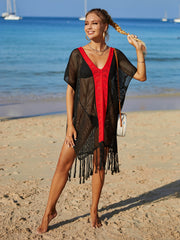 Black crochet cover-up with red V-neck trim and fringe hem, short sleeves.