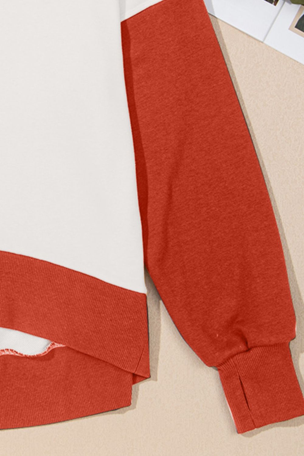 Chic Contrast Crewneck Sweatshirt in white and rust orange with thumbhole cuffs.