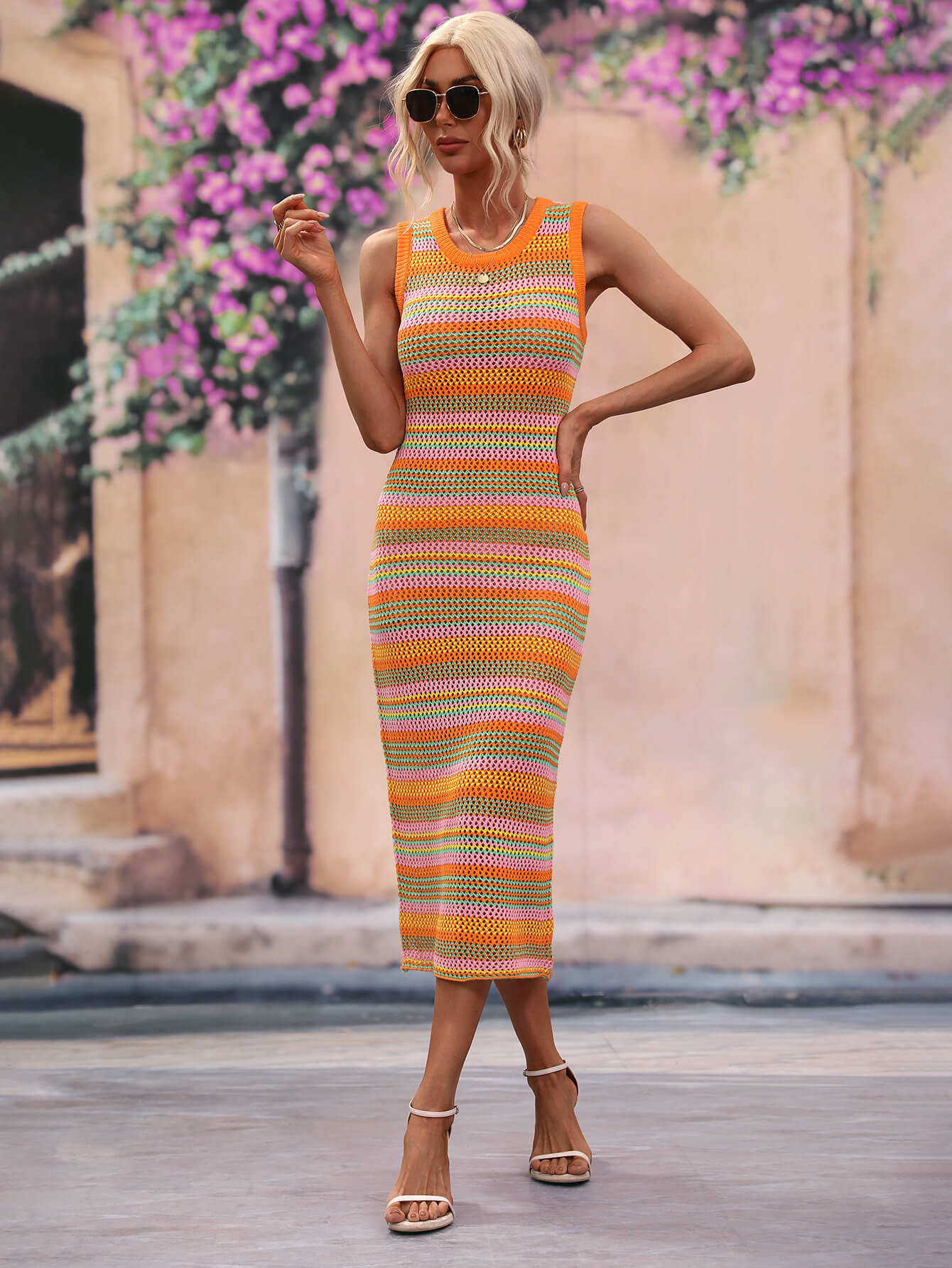 Striped knit sleeveless midi dress in orange and pink with a crochet texture.