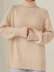 Blush pink cashmere turtleneck sweater with raglan sleeves and ribbed cuffs and hem.