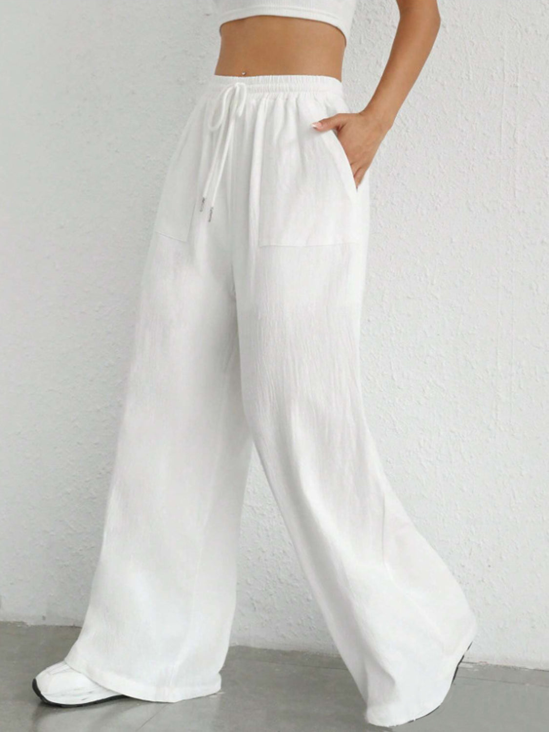 White linen wide-leg drawstring trousers with pockets