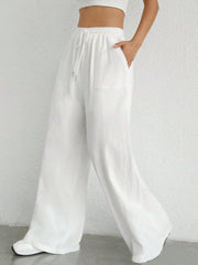 White linen wide-leg drawstring trousers with pockets