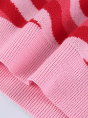 Pink knit tank top with red heartbeat intarsia pattern and ribbed texture.