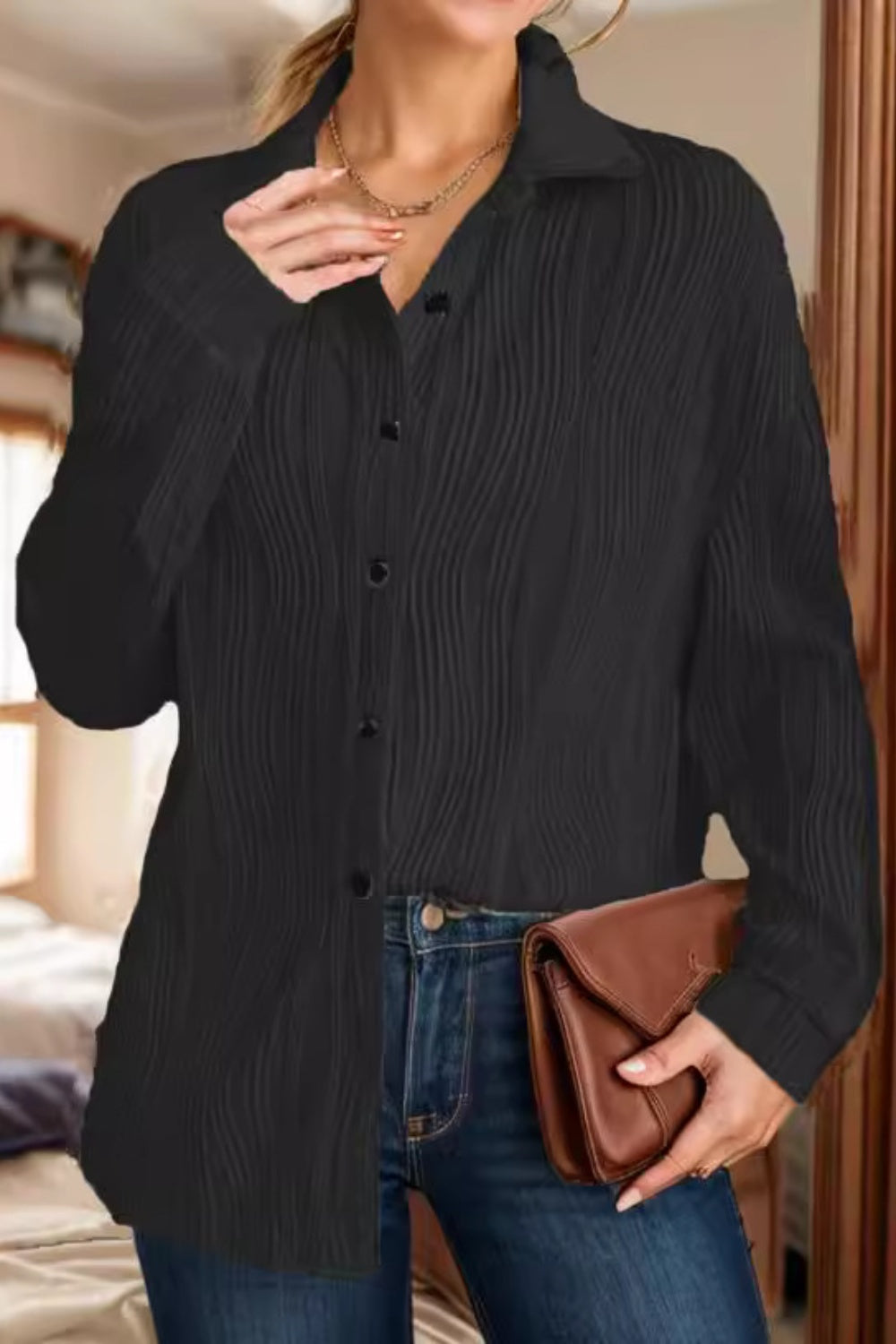 Black pleated wave oversized button-down shirt with a collared neckline and long sleeves.
