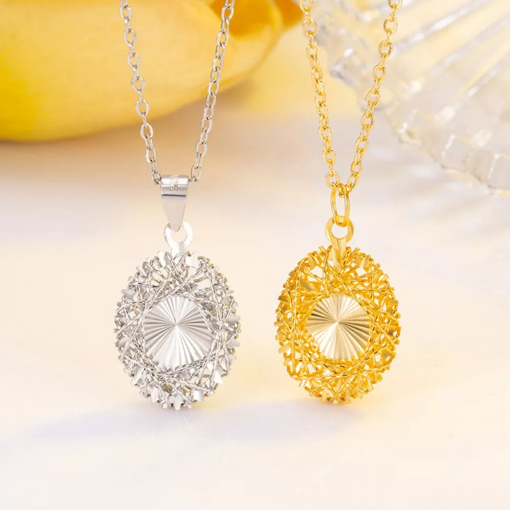 Elegant openwork pendant necklaces in silver and gold, with delicate chain detail.