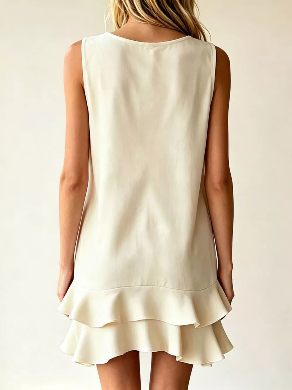 Tiered ruffle mini dress in Lotus Color with a scoop neckline and sleeveless design.