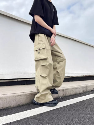 Khaki cargo sweatpants with multiple pockets and adjustable drawstrings at the hem.