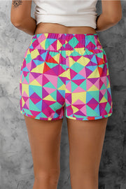 Geometric Prism Running Shorts in multicolor with elastic waistband and athletic cut.