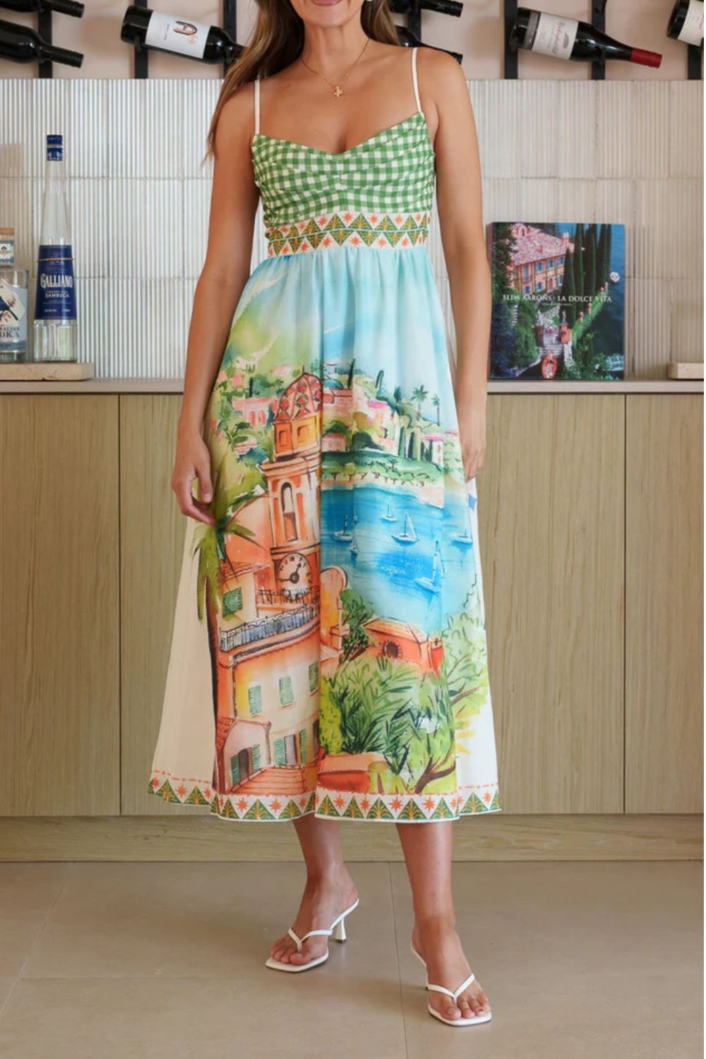 Gingham bodice midi dress with scenic coastal print and decorative trim.
