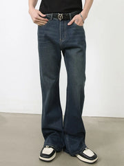 Dark flared denim jeans with subtle fading and bootcut leg