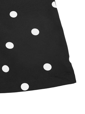 Black polka dot jumpsuit with wide legs and a strapless neckline.
