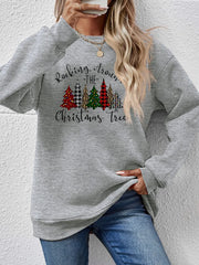 Gray crewneck sweatshirt with Christmas trees graphic and text.