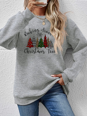 Gray crewneck sweatshirt with Christmas trees graphic and text.