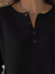 Black long-sleeve knit top with button detail and crew neckline