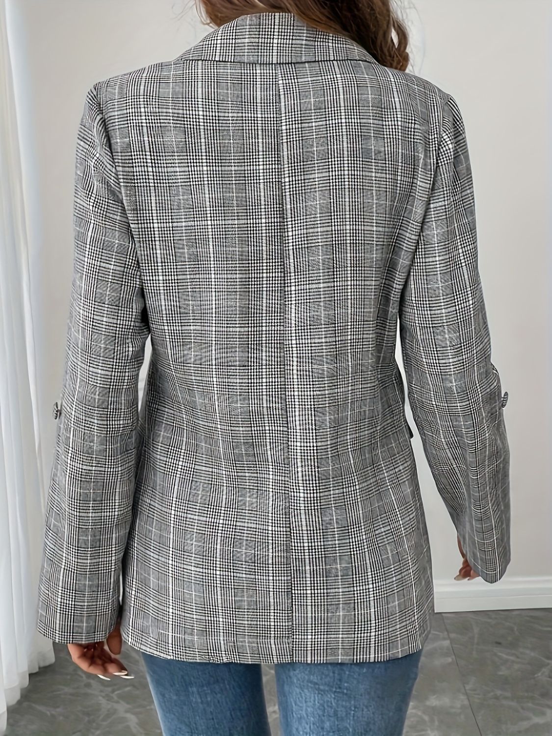 Light gray plaid blazer with buttoned cuffs and lapel collar.