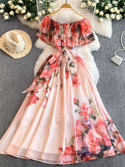 Botanical off-shoulder a-line dress in light pink with floral print and belted waist.
