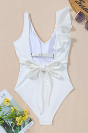 White ruffled wrap swimsuit with textured fabric and back tie detail.
