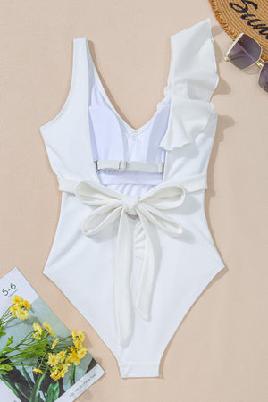 White ruffled wrap swimsuit with textured fabric and back tie detail.
