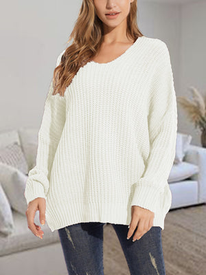 Relaxed fit ivory ribbed knit sweater with V-neck and batwing sleeves.