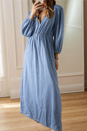 Light denim maxi dress with V-neck, cinched waist, and long balloon sleeves.