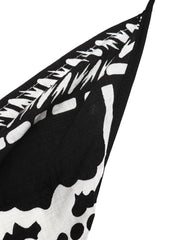 Black and white floral print halter neck maxi dress detail with asymmetrical hem.