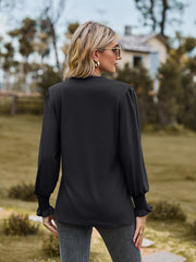 Black blouse with pleated yoke and shirred cuffs