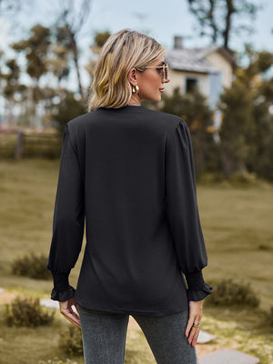 Black blouse with pleated yoke and shirred cuffs