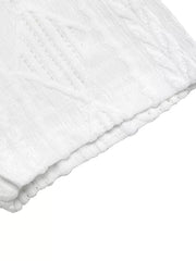 White textured knit maternity t-shirt with subtle diamond pattern and bow detail.