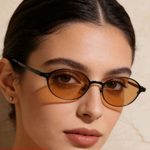 Chic vintage oval sunglasses with amber lenses and black frames.