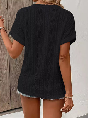 Black diamond pattern short-sleeve t-shirt with textured knit and open weave details.