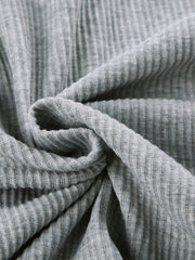 Grey ribbed knit fabric detail of a cozy hoodie and short set.
