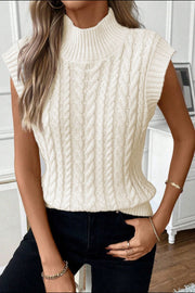 Ivory cable knit mock neck vest with chunky knit texture and sleeveless design.