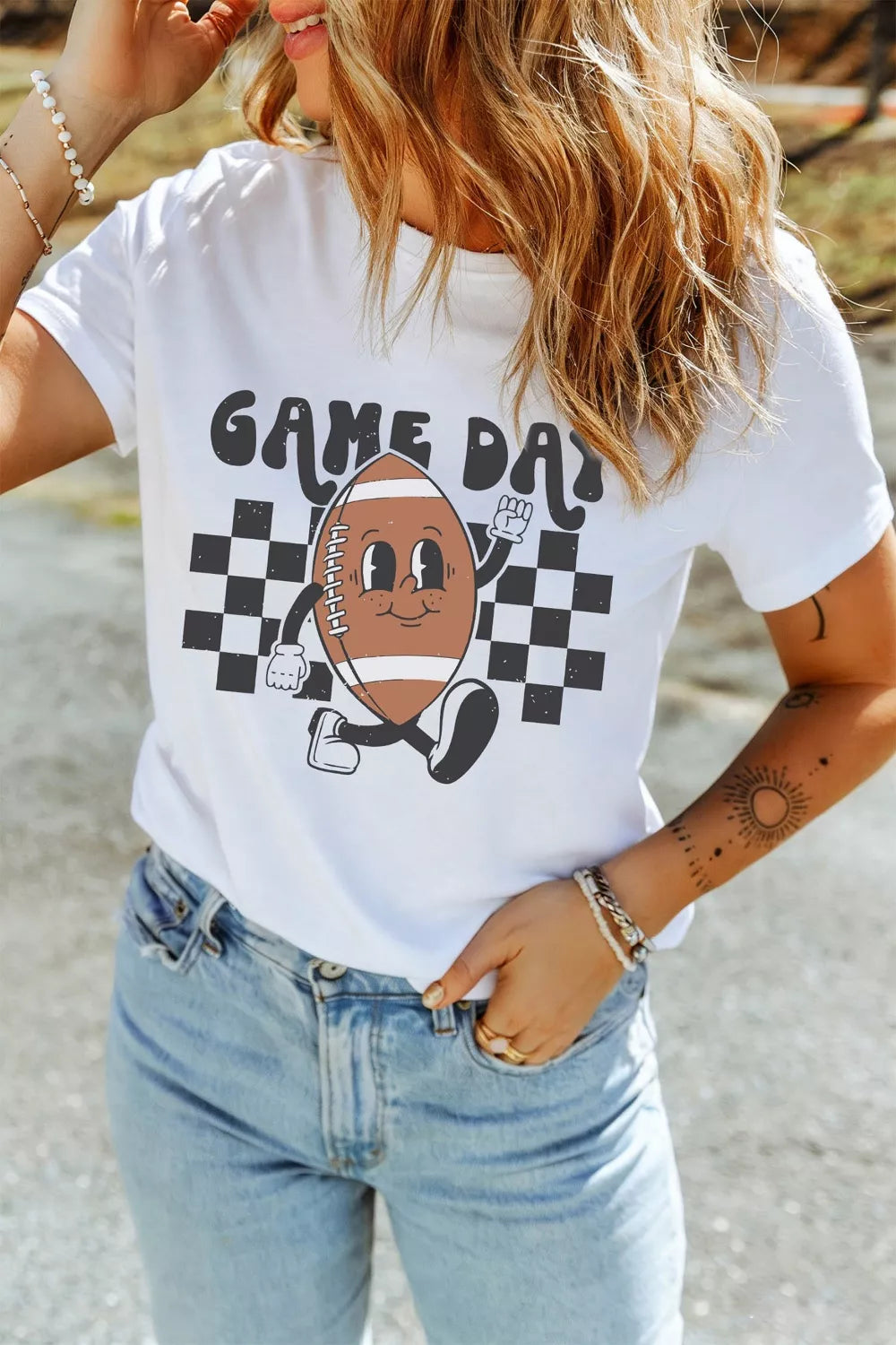 White polyester t-shirt with playful football graphic and "Game Day" text.