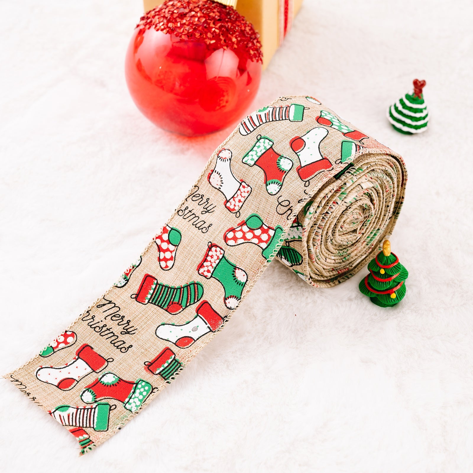 Festive holiday ribbon in beige burlap with a Merry Christmas stocking pattern in red and green.