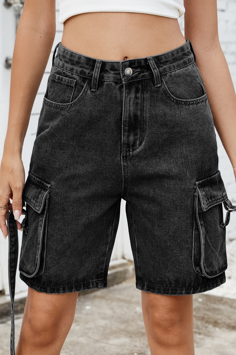 Black denim cargo shorts with straps and buckle details