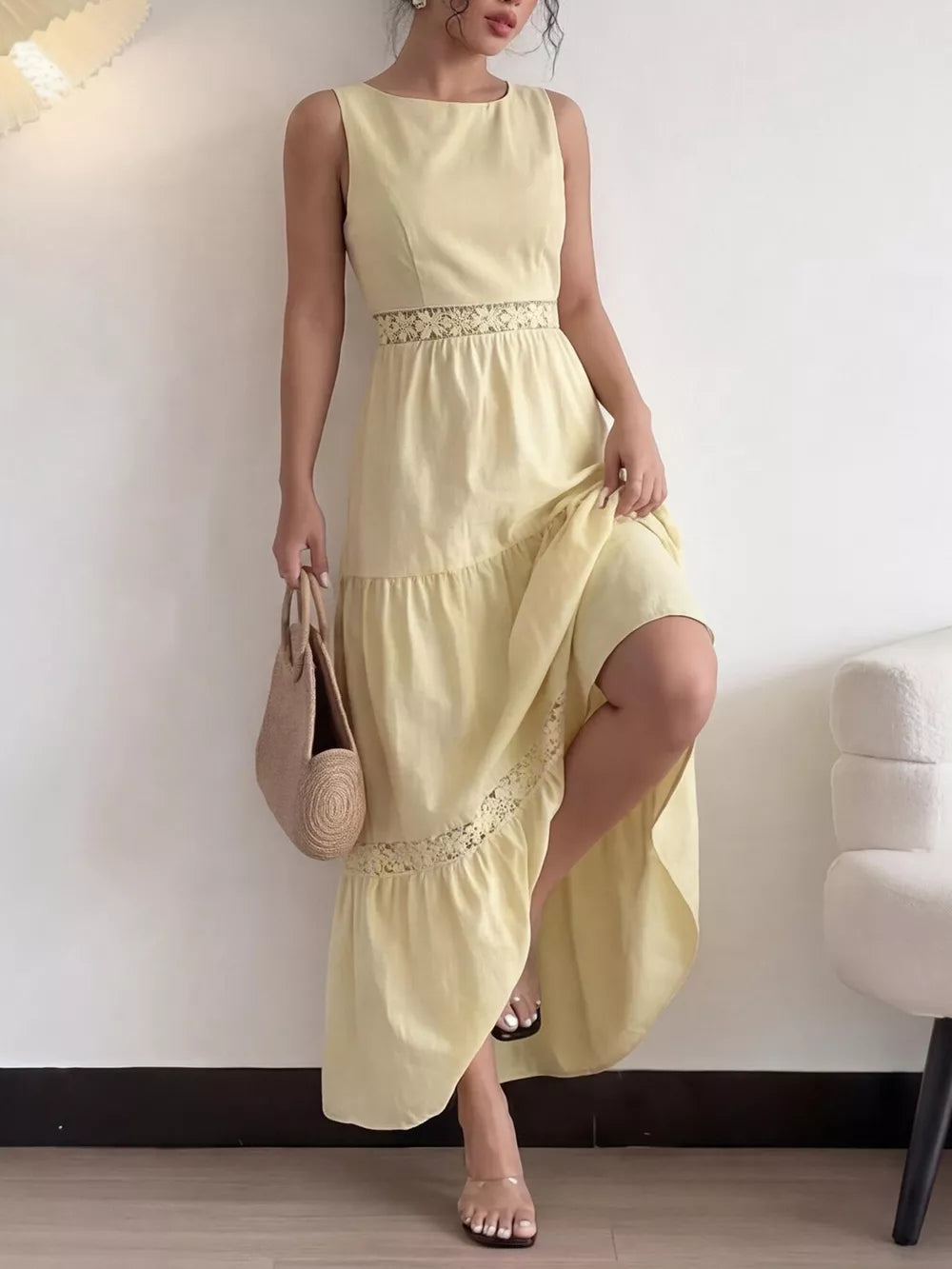 Yellow lace-trimmed maxi dress with boat neckline and tiered skirt.