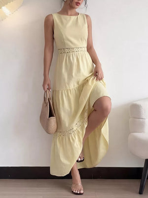 Yellow lace-trimmed maxi dress with boat neckline and tiered skirt.