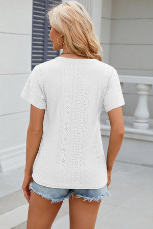 White eyelet wrap V-neck top with short sleeves and a casual fit.