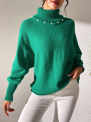 Green knit sweater with pearl neckline and dolman sleeves.
