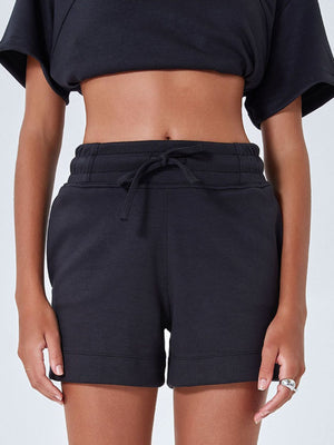 Black drawstring pocket shorts with cuffed hem and elastic waistband