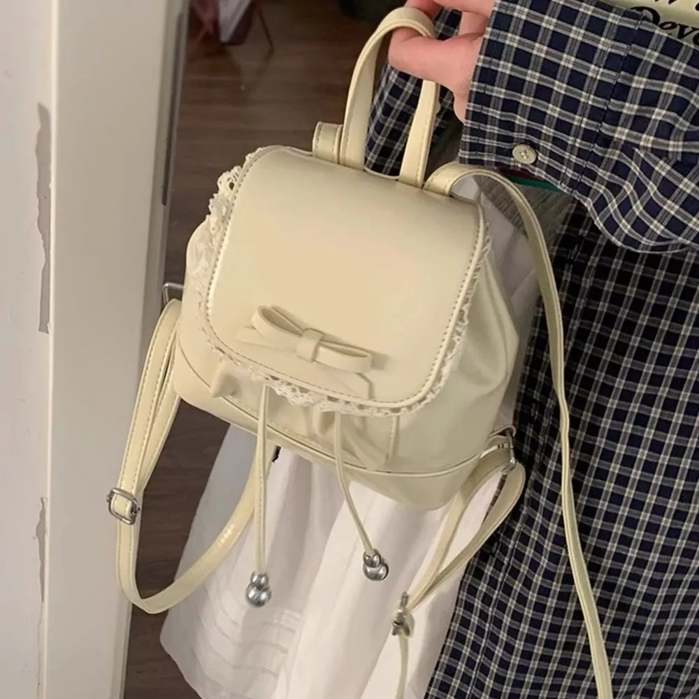 Cream mini backpack with lace trim and bowknot detail