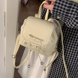 Cream mini backpack with lace trim and bowknot detail