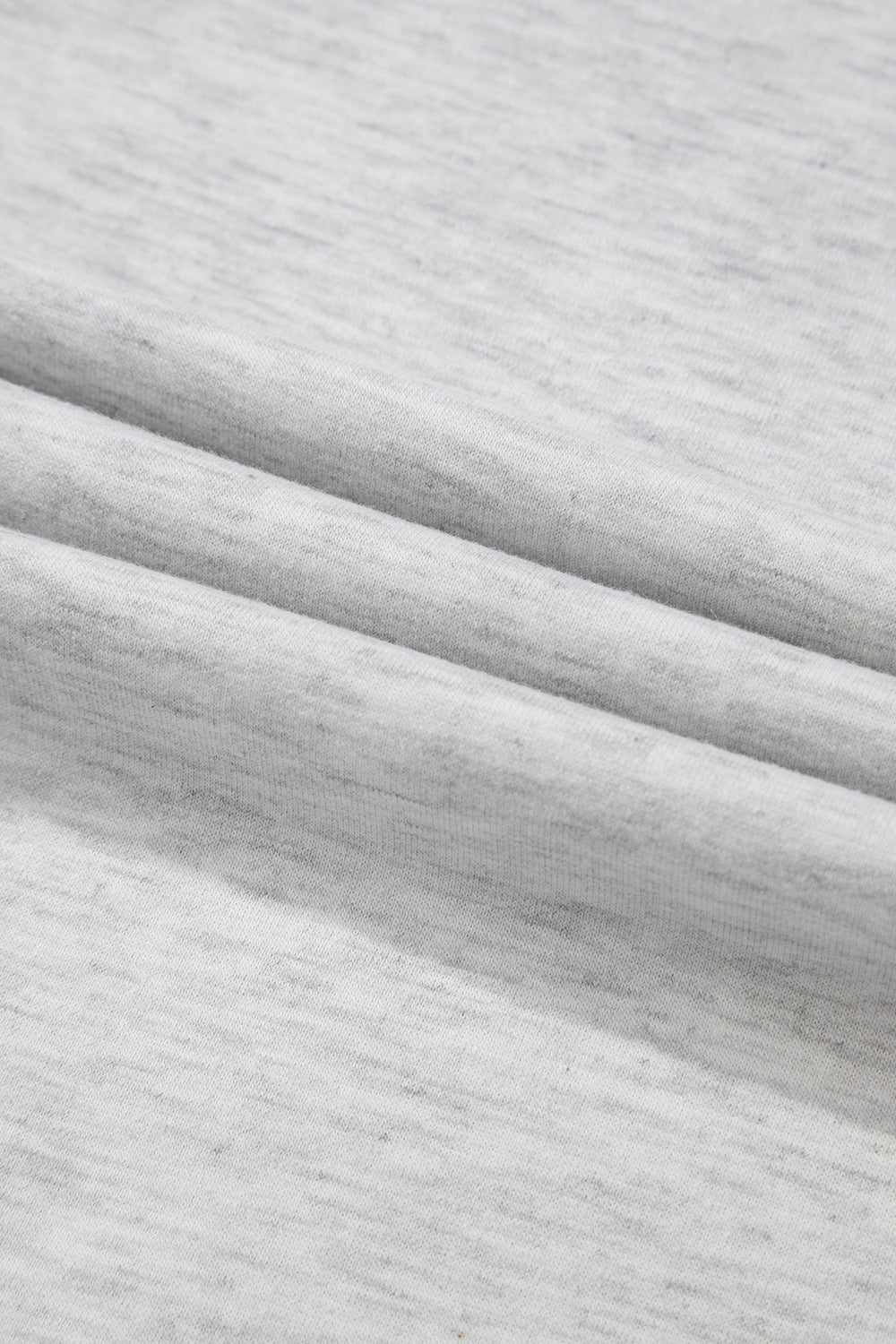 Gray waffle knit henley top with a textured fabric detail.