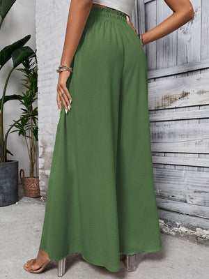 Ruffled waistline palazzo trousers in dark green, featuring a wide leg and flowy silhouette.