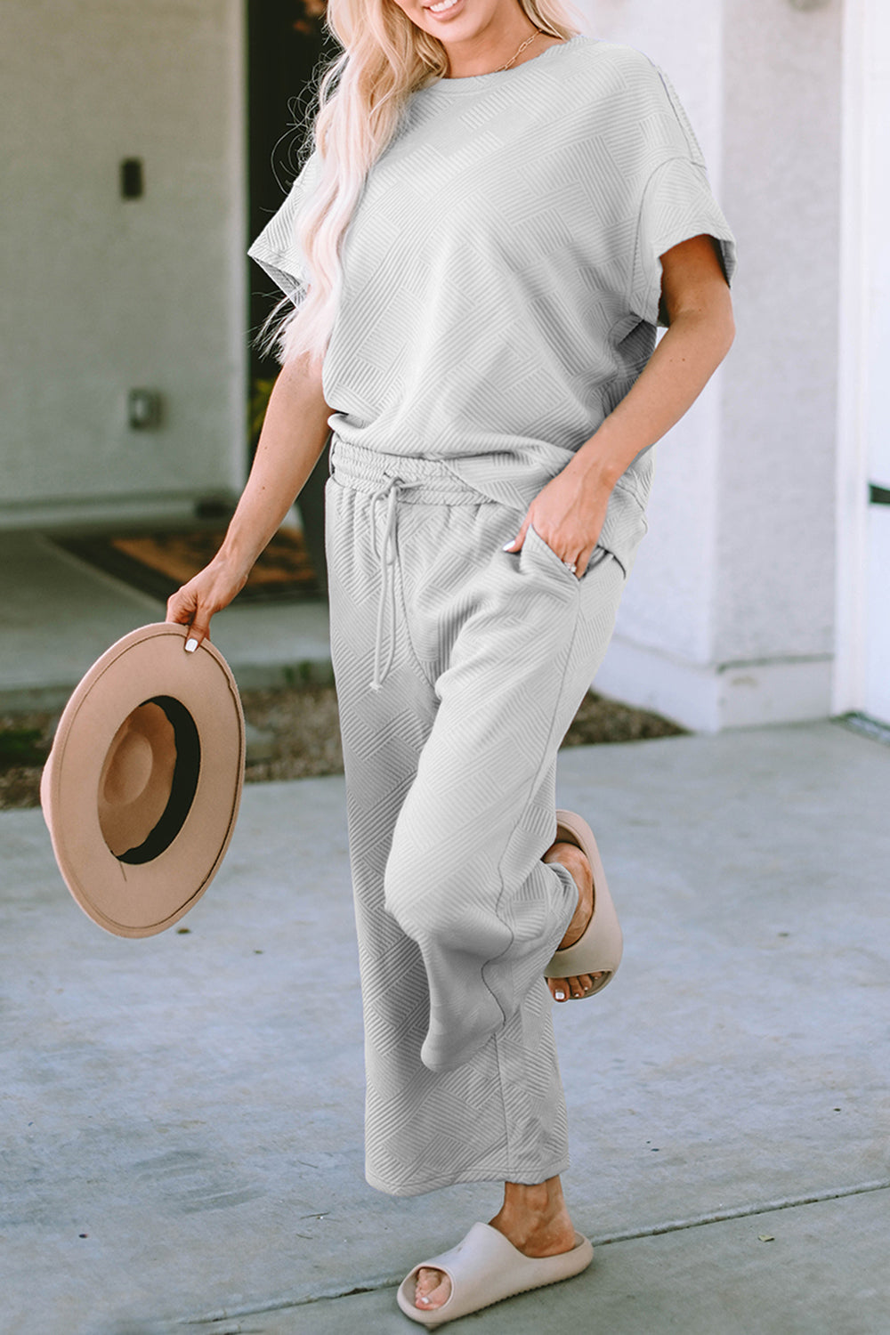 Light gray textured knit tee and wide leg pants set with drawstring waist and pockets.