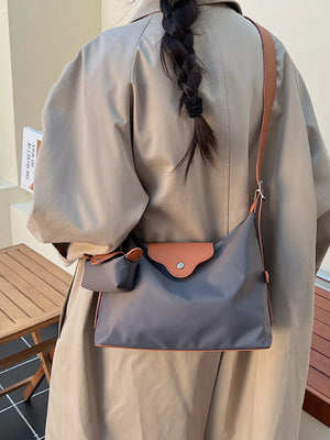 Gray canvas hobo bag with coin purse and tan trim.